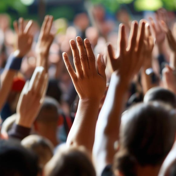 community and collaboration raise hand in a crowd